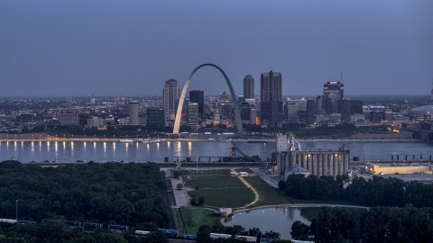 DXP001_037_0001 - Aerial stock photo of The Gateway Arch at twilight, visible from across the Mississippi River, Downtown St. Louis, Missouri