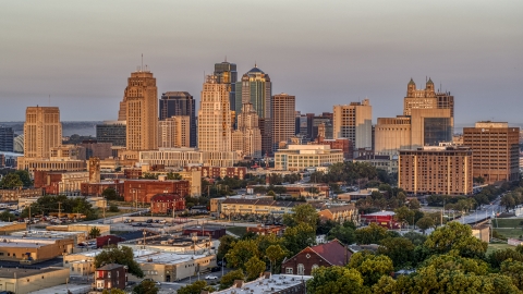 DXP001_040_0002 - Aerial stock photo of The city skyline seen from trees at sunrise, Downtown Kansas City, Missouri