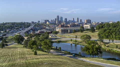 DXP001_045_0005 - Aerial stock photo of The city's skyline seen from green lawns beside a small lake, Kansas City, Missouri
