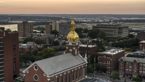DXP001_051_0007 - Aerial stock photo of A brick cathedral with golden steeple at sunset in Downtown Kansas City, Missouri