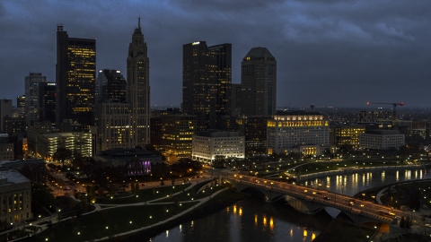 DXP001_088_0006 - Aerial stock photo of The city's skyline beside a bridge and river at twilight, Downtown Columbus, Ohio