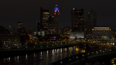 DXP001_088_0014 - Aerial stock photo of LeVeque Tower and bridge spanning the river at night, Downtown Columbus, Ohio