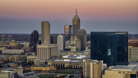 DXP001_092_0019 - Aerial stock photo of A hotel at sunset, city skyline in the background in Downtown Indianapolis, Indiana