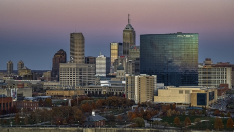 DXP001_092_0020 - Aerial stock photo of The city's tall skyline and a hotel at sunset in Downtown Indianapolis, Indiana
