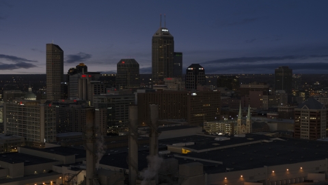 DXP001_093_005 - Aerial stock photo of Giant skyscrapers of the city skyline at twilight, seen from smoke stacks, Downtown Indianapolis, Indiana