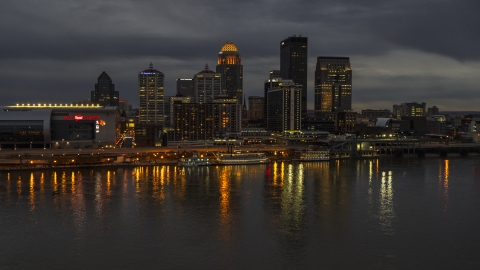 DXP001_096_0014 - Aerial stock photo of A view of the skyline lit up at twilight, seen from Ohio River, Downtown Louisville, Kentucky