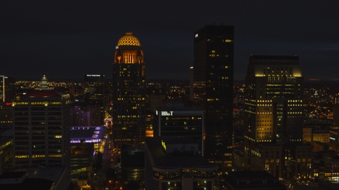 DXP001_096_0023 - Aerial stock photo of Towering skyscrapers lit up at twilight, Downtown Louisville, Kentucky