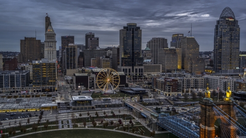 DXP001_097_0013 - Aerial stock photo of The city skyline and the Ferris wheel at sunset, Downtown Cincinnati, Ohio