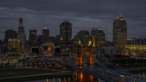 DXP001_098_0005 - Aerial stock photo of Roebling Bridge and city skyline lit up at twilight, Downtown Cincinnati, Ohio