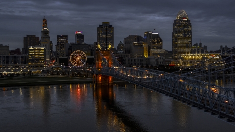 DXP001_098_0007 - Aerial stock photo of The lights of city skyline and bridge at twilight seen from the river, Downtown Cincinnati, Ohio