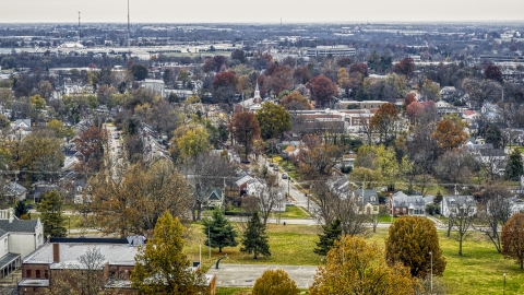 DXP001_099_0014 - Aerial stock photo of A church steeple behind suburban neighborhood in Lexington, Kentucky