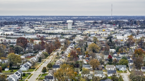 DXP001_099_0017 - Aerial stock photo of Homes with view of a water tower surrounded by warehouses in Lexington, Kentucky
