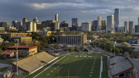 DXP002_105_0002 - Aerial stock photo of A view of skyscrapers and office buildings at sunset in Downtown Austin, Texas, seen from football stadium