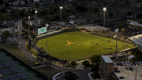 DXP002_105_0019 - Aerial stock photo of View of a baseball game at a stadium at the University of Texas at twilight, Austin, Texas