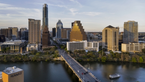 DXP002_110_0003 - Aerial stock photo of Waterfront skyscrapers across Lady Bird Lake at sunset in Downtown Austin, Texas