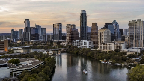 DXP002_110_0005 - Aerial stock photo of A view of Lady Bird Lake and the skyline at sunset in Downtown Austin, Texas