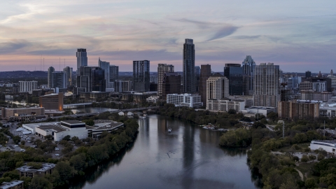 DXP002_110_0009 - Aerial stock photo of A view of of The Austonian and city skyline seen from Lady Bird Lake at twilight in Downtown Austin, Texas
