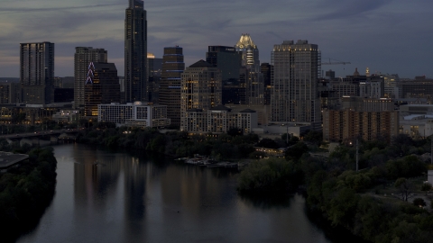 DXP002_110_0019 - Aerial stock photo of San Jacinto Center beside Lady Bird Lake at twilight in Downtown Austin, Texas