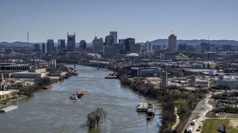 DXP002_112_0007 - Aerial stock photo of A barge on the river and the city's skyline, Downtown Nashville, Tennessee