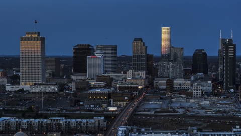 DXP002_115_0005 - Aerial stock photo of A view of light reflecting off skyscrapers in city's skyline, seen from near Church Street at twilight in Downtown Nashville, Tennessee