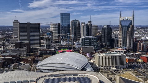 DXP002_117_0009 - Aerial stock photo of The city's skyline behind the arena, Downtown Nashville, Tennessee