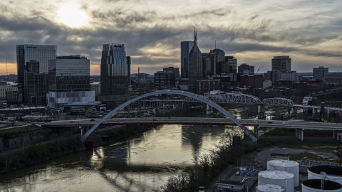 DXP002_119_0007 - Aerial stock photo of The city's skyline and bridges over the Cumberland River at sunset, Downtown Nashville, Tennessee