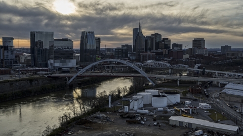 DXP002_119_0008 - Aerial stock photo of City skyline by bridges and Cumberland River at sunset, Downtown Nashville, Tennessee