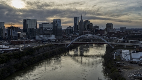 DXP002_119_0009 - Aerial stock photo of The city skyline behind a bridge on Cumberland River at sunset, Downtown Nashville, Tennessee