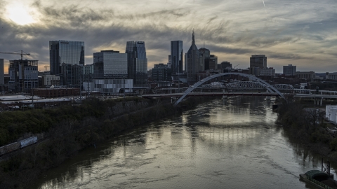 DXP002_119_0011 - Aerial stock photo of The city's skyline, bridges over the Cumberland River at sunset, Downtown Nashville, Tennessee