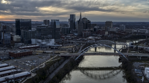 DXP002_119_0015 - Aerial stock photo of The skyline and a bridge over the Cumberland River at sunset, Downtown Nashville, Tennessee