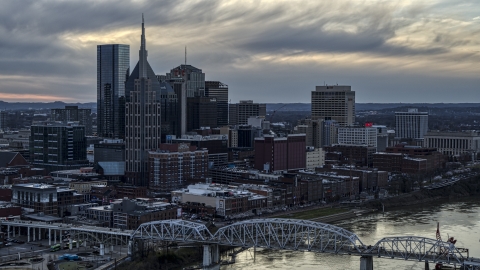 DXP002_120_0005 - Aerial stock photo of The riverfront skyline, and a bridge spanning the Cumberland River at sunset, Downtown Nashville, Tennessee