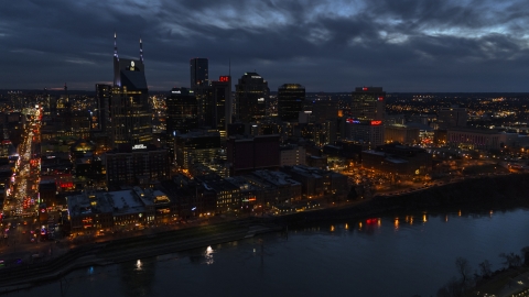 DXP002_121_0004 - Aerial stock photo of A view across the river toward the city's skyline at twilight, Downtown Nashville, Tennessee
