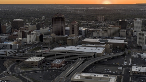 DXP002_122_0010 - Aerial stock photo of Office high-rises and convention center near office tower and shorter hotel tower at sunset, Downtown Albuquerque, New Mexico