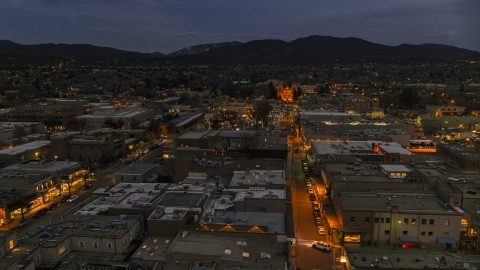 DXP002_132_0004 - Aerial stock photo of The cathedral lit up at night at the end of San Francisco Street, Santa Fe, New Mexico