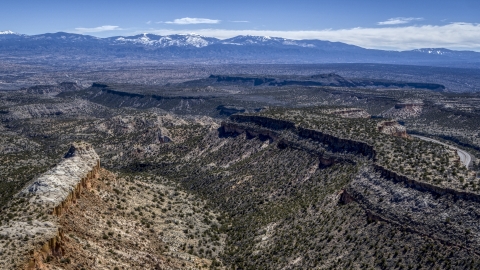 DXP002_133_0011 - Aerial stock photo of Flat desert mesas and distant mountains in New Mexico