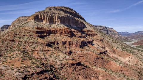 DXP002_135_0005 - Aerial stock photo of The side of a tall butte with steep slopes, New Mexico