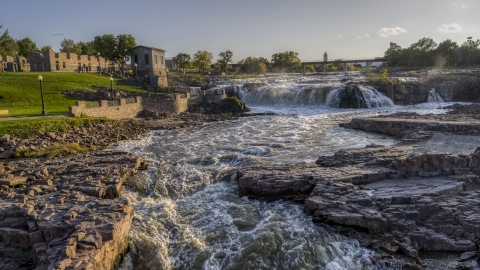 DXP002_176_0005 - Aerial stock photo of A low view of waterfalls at sunset in Sioux Falls, South Dakota
