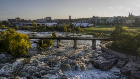DXP002_176_0007 - Aerial stock photo of A bridge spanning the river at sunset in Sioux Falls, South Dakota