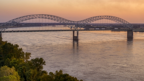 DXP002_181_0001 - Aerial stock photo of Traffic crossing the Hernando de Soto Bridge at sunset, Downtown Memphis, Tennessee