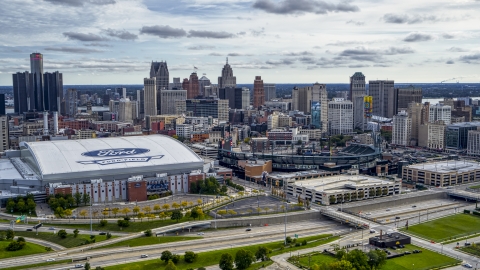DXP002_191_0004 - Aerial stock photo of Football and baseball stadiums with view of skyline, Downtown Detroit, Michigan