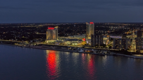 DXP002_193_0006 - Aerial stock photo of The Caesar Windsor hotel and casino across the river at night, Windsor, Ontario, Canada