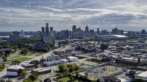 DXP002_195_0001 - Aerial stock photo of The city's skyline seen from brick industrial buildings, Downtown Detroit, Michigan