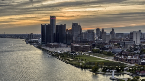 DXP002_197_0005 - Aerial stock photo of The GM Renaissance Center and the city's skyline seen from river at sunset, Downtown Detroit, Michigan