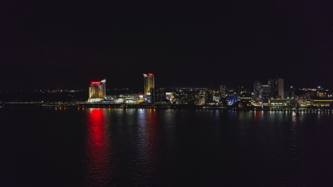 DXP002_199_0001 - Aerial stock photo of A view of Caesars Windsor hotel and casino across the river at nighttime, Windsor, Ontario, Canada