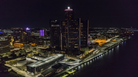 DXP002_199_0004 - Aerial stock photo of The GM Renaissance Center by the river at night, Downtown Detroit, Michigan