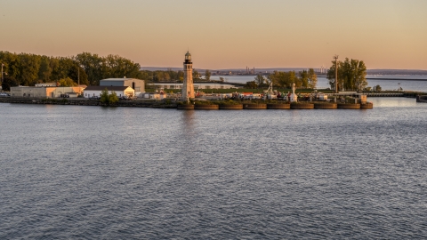 DXP002_204_0009 - Aerial stock photo of The Lake Erie lighthouse at sunset, Buffalo, New York