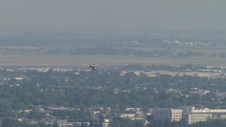 AF0001_000011 - HD aerial stock footage of tracking a helicopter flying over residential neighborhoods, Central Valley, California