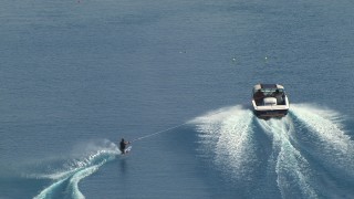 AF0001_000015 - HD aerial stock footage of tracking a woman water skiing behind a boat, Central Valley, California