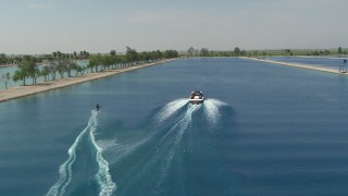 AF0001_000021 - HD aerial stock footage of tracking a woman waterskiing behind a boat in the Central Valley, California