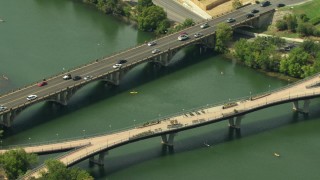 AF0001_000117 - HD stock footage aerial video of Lamar Boulevard Bridge and Pfluger Pedestrian Bridge over Lady Bird Lake, Downtown Austin, Texas